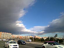 A street of Madrid under a relatively blue sky in winter
